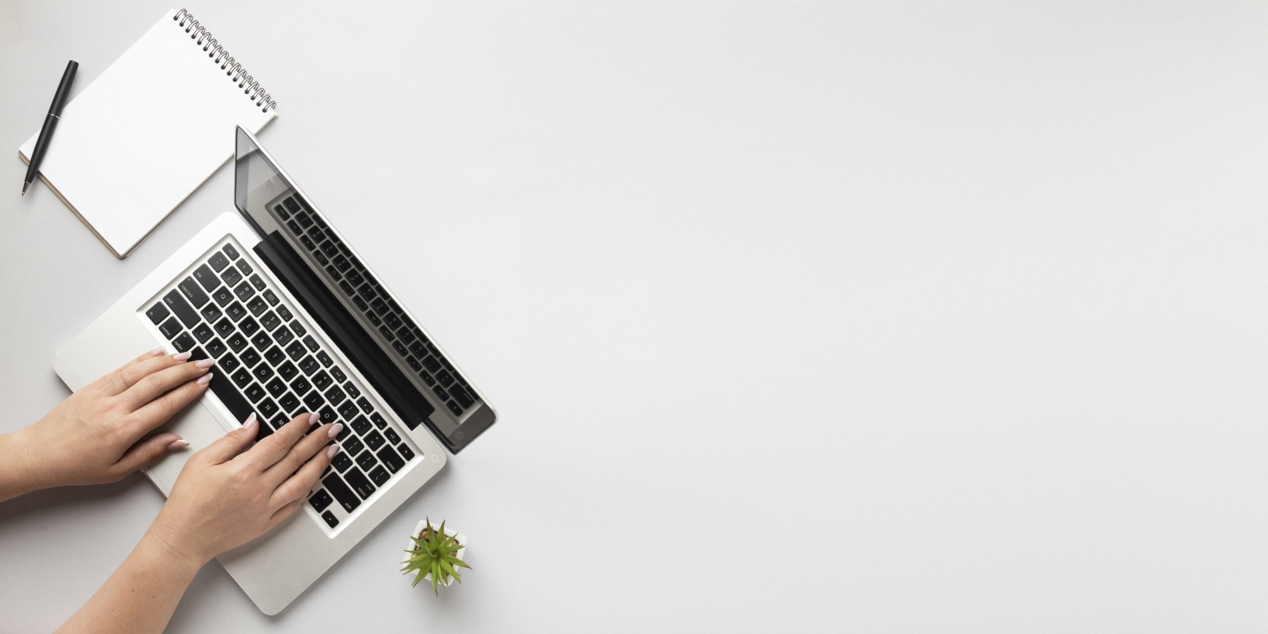 top-view-person-writing-on-laptop-with-copy-space